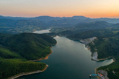 High angle view of river and mountains against sky