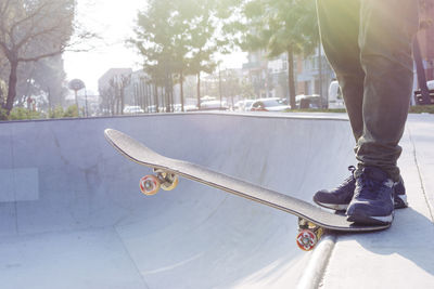 Low section of man skateboarding in park