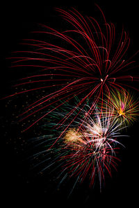 Low angle view of firework display against sky at night