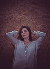 Portrait of young woman sitting on field