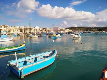 Boats moored at harbor in city