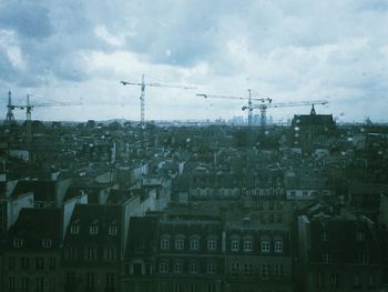 Buildings against cloudy sky