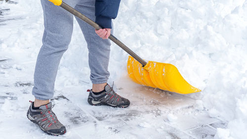 Low section of man standing on snow