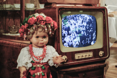 Close-up of toy by television