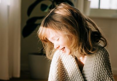 Portrait of girl looking away at home