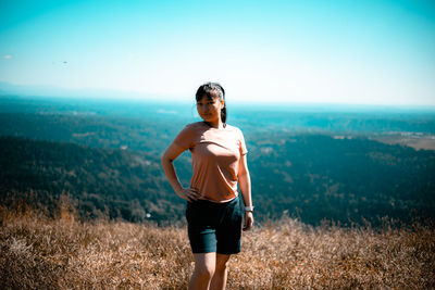 Full length of man standing on field against sky