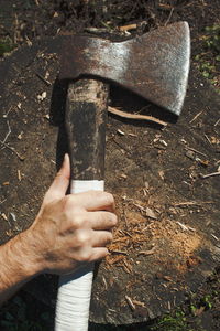 High angle view of person hand holding metal