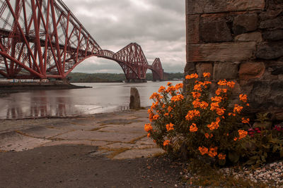 View of bridge over river against cloudy sky