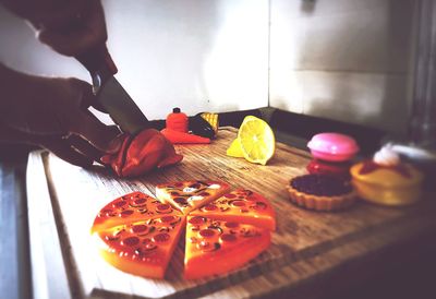 Midsection of person preparing food in kitchen