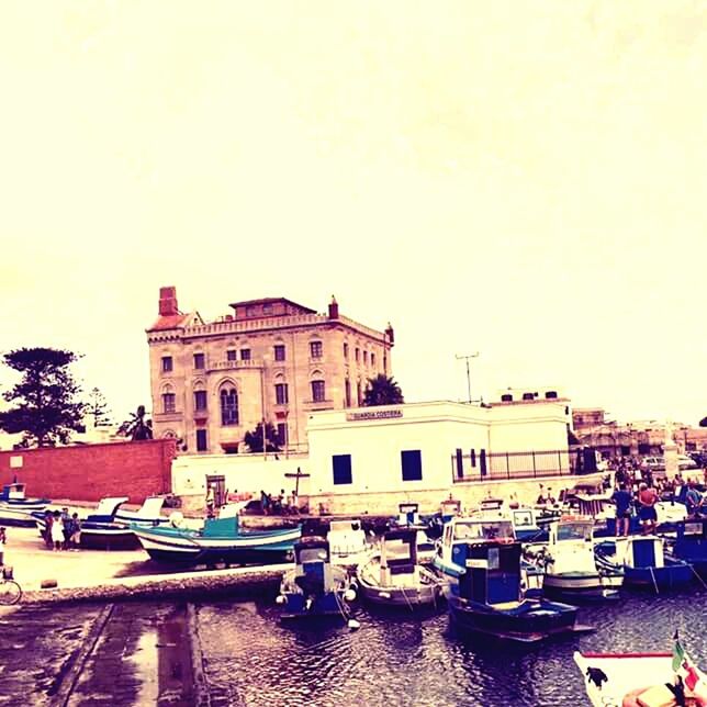 BOATS MOORED AT WATERFRONT