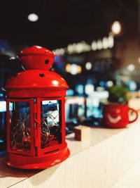 Close-up of red lantern on retaining wall at night