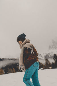 Rear view of woman standing on snow