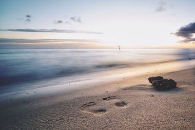 Scenic view of beach against sky during sunset