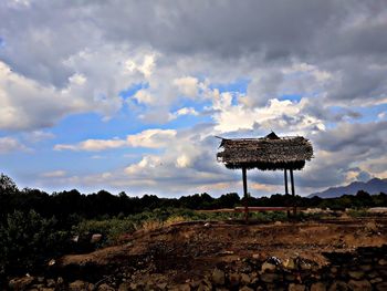 Lifeguard hut on field against sky