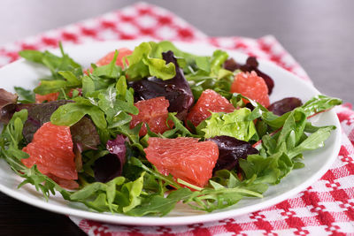 Grapefruit salad, a mix of lettuce, arugula and olive dressing. vegetarian food.