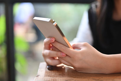 Midsection of woman using mobile phone