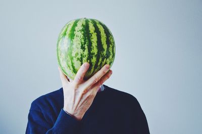 Cropped image of man holding watermelon