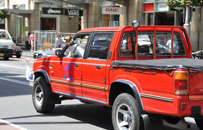 Car on street against buildings in city