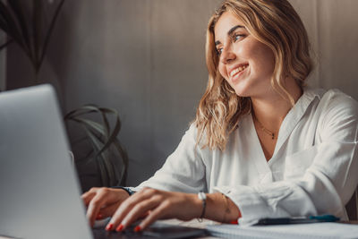 Young woman using laptop at office