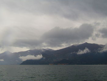 Scenic view of sea and mountains against sky