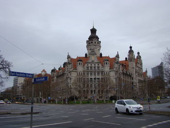 Cars on street against buildings in city