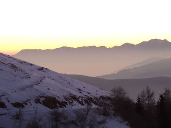 Scenic view of mountains against clear sky during sunset