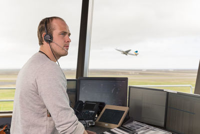 Male dispatcher controlling flights in airport