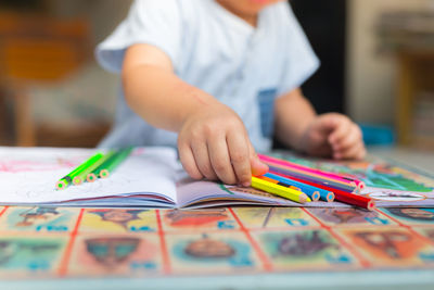 Close-up of boy wearing hat on table