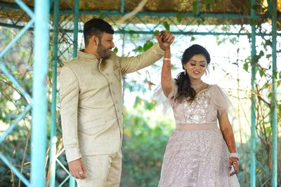 Portrait of young couple standing outdoors