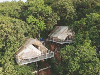 High angle view of abandoned house amidst trees in forest