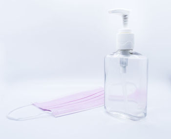 Close-up of water bottle on table against white background