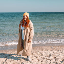 Young woman standing at beach