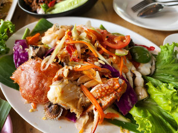 Close-up of sea food somtum thai traditional food in plate on table