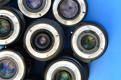 Directly above shot of various lenses on blue background