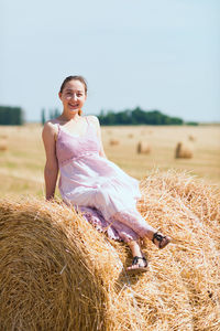 Portrait of woman standing on field