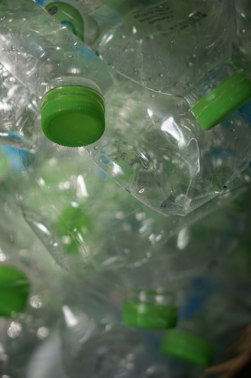 HIGH ANGLE VIEW OF GLASS BOTTLES IN CONTAINER
