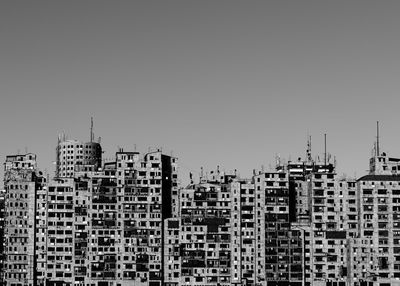 Buildings in city against clear sky