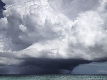 Scenic view of sea against storm clouds