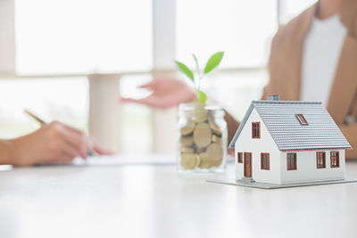 Midsection of woman holding toy on table