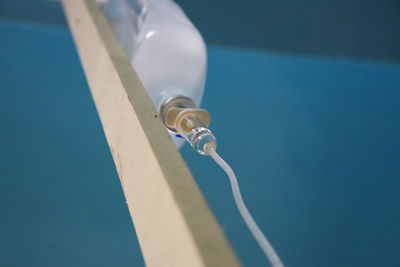 Low angle view of rope against blue sky