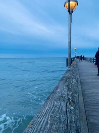 Pier over sea against sky