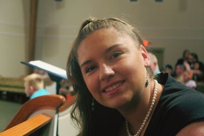 Portrait of smiling woman at classical concert