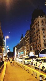 Illuminated city street and buildings at night