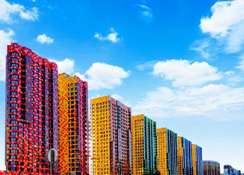 Low angle view of multi colored modern buildings against sky