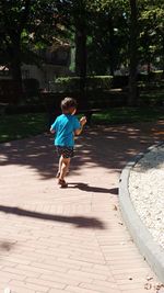 Full length of boy playing on tree