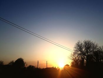 Low angle view of silhouette trees against clear sky