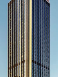 Low angle view of modern building against clear blue sky