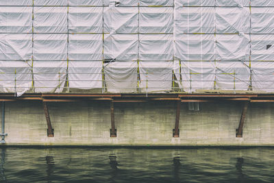 Incomplete built structure covered with tarpaulin by spree river