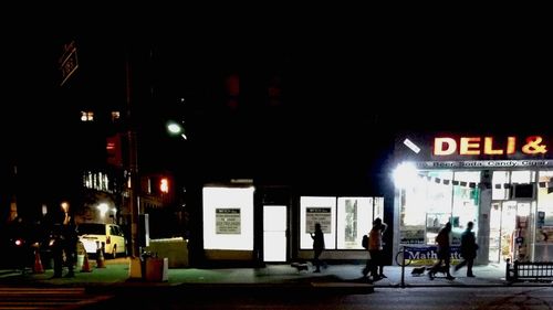 Man in illuminated city at night