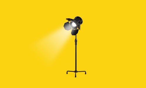 Electric lamp against yellow wall